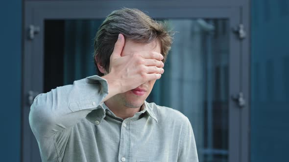 Young Man Businessman Employer Covering Hiding Face Eyes with Hands Peeping Through Fingers Because