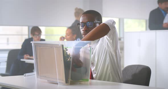 Upset African Office Manager Packing Box and Leaving Office