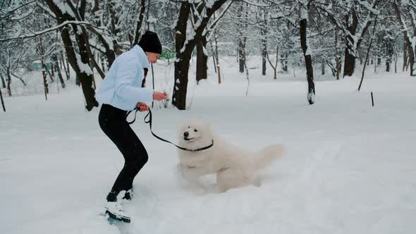 Girl with Dog in the Park in Winter