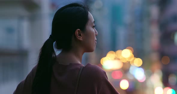 Woman look around in the downtown at night