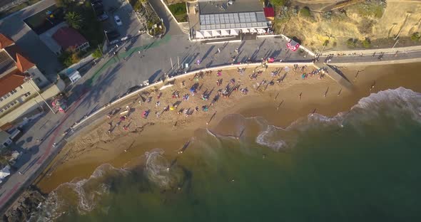 Aerial lock down over amazing and short Cascais beach in Sao Joao in Estoril