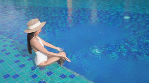 Young asian woman enjoy around outdoor swimming pool for leisure