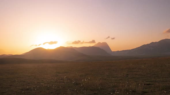 Time lapse: clouds moving in the sky, sunset view point over rocky mountains, highlands and pastures