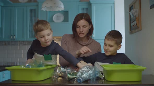 Family sorting home garbage for recycling plastic and tin 