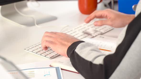 Home office worker using keyboard.