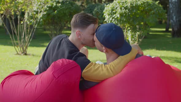 Rear View of Homosexual Couple Kissing Outdoors