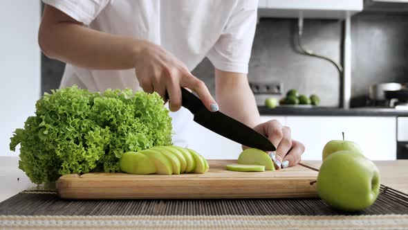 Woman Cooking Healthy Food in the Kitchen She Cutting Sliced Green Apple