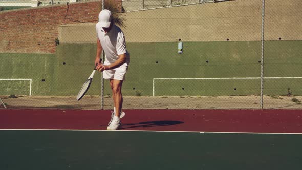 Man playing tennis on a sunny day
