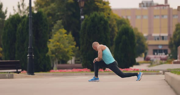 Young Man in Sports Uniform is Being Trained on the Street