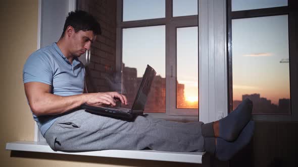 Happy Man Uses at Laptop and Experiences Joy of Victory and Success at Home