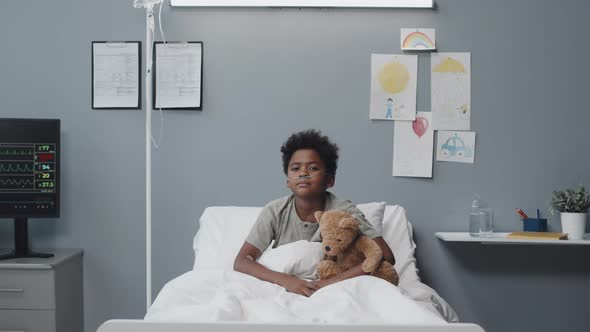 Boy with Stuffed Bear Posing in Clinic