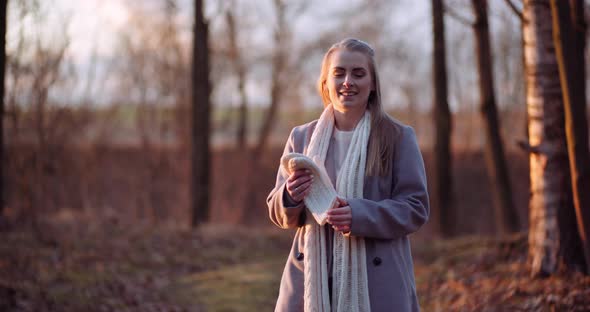 Woman Warming Up Hands in Autumn