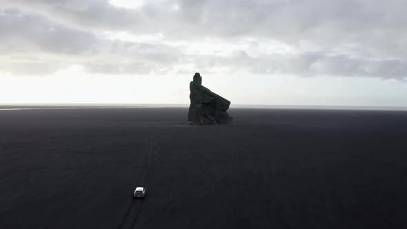 Revealing Drone Shot of Sandy Horizon and Sea Stack in Iceland