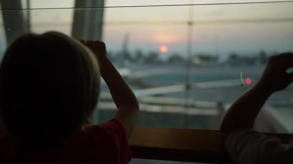 Child Standing Near the Window at the Airport