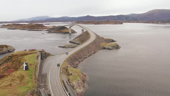 Aerial Orbit Of Atlantic Ocean road With Cars Crossing Storseisundet Bridge, Norway. - Drone shot