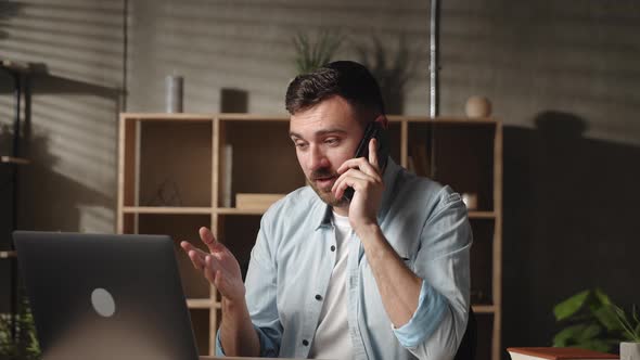 Happy Young Businessman Holding Cellphone Call Conversation with Colleagues or Client Working on