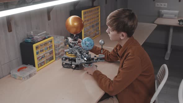 Teen Boy Making Solar System Model
