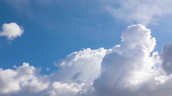 Forming clouds on blue sky time lapse