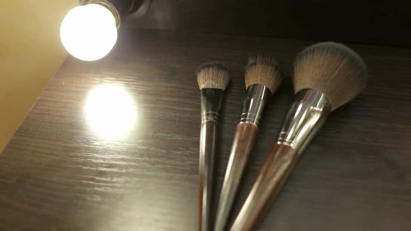 Closeup of Three Makeup Brushes on the Table