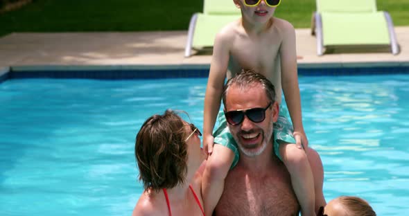 Family enjoying in swimming pool