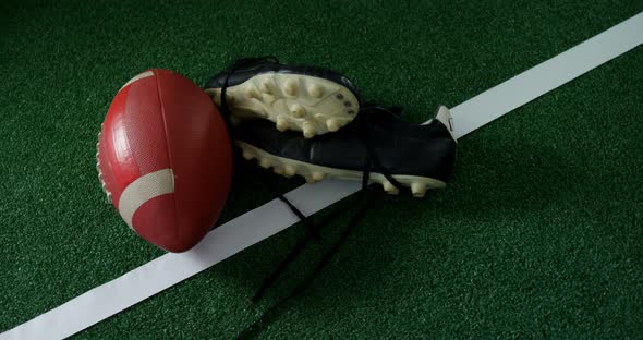 Rugby ball and cleat on marking line 4k