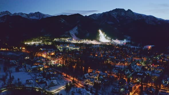 Illuminated Zakopane city in winter at night, aerial view