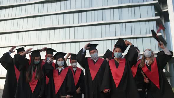 University Graduates Rejoice at the End of Their Studies Graduates in Medical Masks They Throw Hats