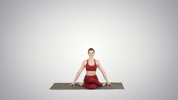 Young attractive woman practicing yoga sitting in Gomukasana