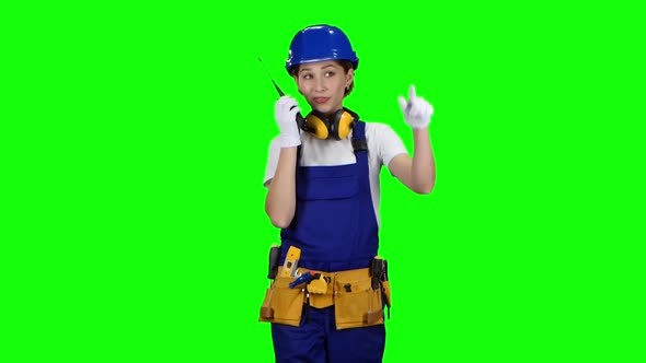 Engineer Girl Wearing Glasses and Wearing Talks on the Walkie Talkie, Green Screen