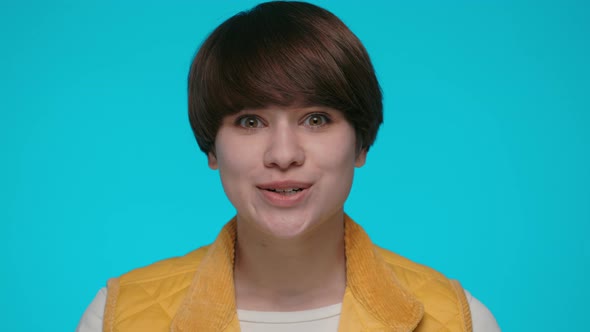 Surprised Young Woman Posing Over Blue Background