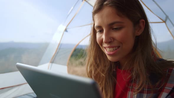 Happy Female Tourist Having Conversation By Video Call Online on Tablet Computer