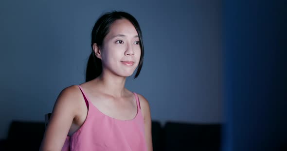 Young woman working on computer at night 