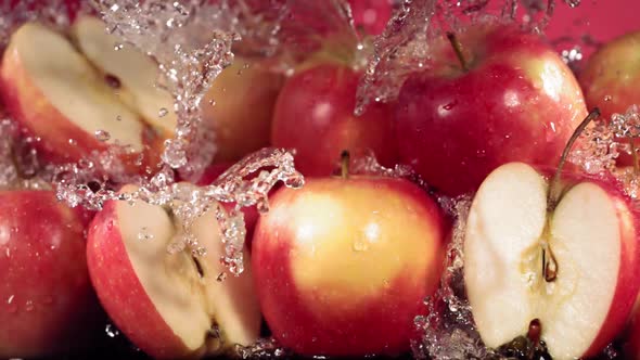 Slow Motion Shot of Red Apple Water Splashing Through Apple Slices