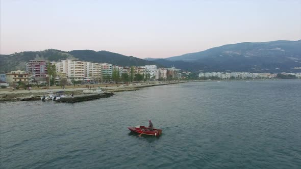 Man paddling boat on the water in Albania