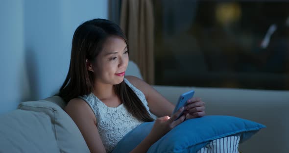 Woman use cellphone for online shopping at night