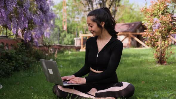 Woman Using Laptop in the Park