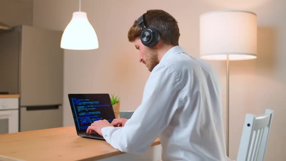 Male Programmer is Working on Creating Software Typing Program Code on a Laptop Keyboard Programmer