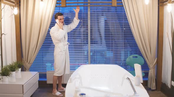 Wealthy Young Man Resting in a Luxurious Spa. Man Waiting for Start of Procedure Standing at