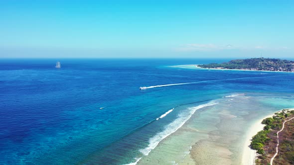 Tropical above island view of a summer white paradise sand beach and aqua blue ocean background in v