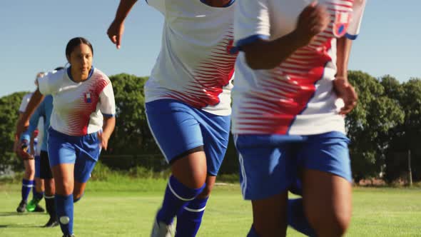 Female soccer team running behind each other. 4k