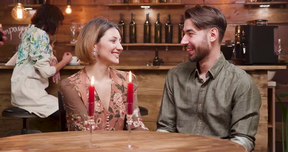 Young Beautiful Couple Clinking Glasses with Wine