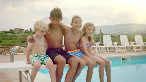 Four Happy Kids Swaying by the Pool Side