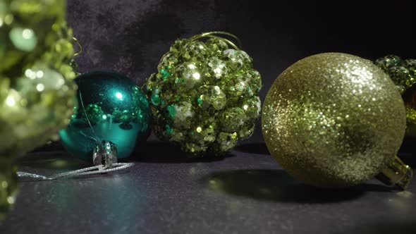 Green Christmas Tree Baubles with Glitter on Dark Table