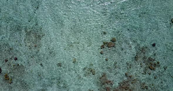 Beautiful birds eye tourism shot of a white sandy paradise beach and turquoise sea background