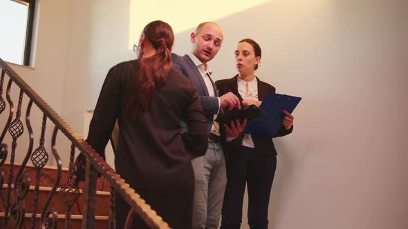 Business Team Walking on Stairs Meeting Colleagues Working