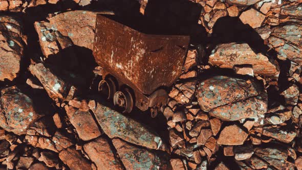 Abandoned Rusty Mine Cart on Rocks alt