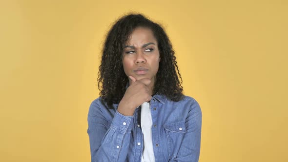 Thinking African Girl Got New Idea Isolated on Yellow Background