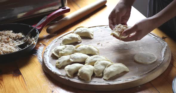 The raw traditional Ukrainian hand-made vareniki (dumpling) with cabbage inside