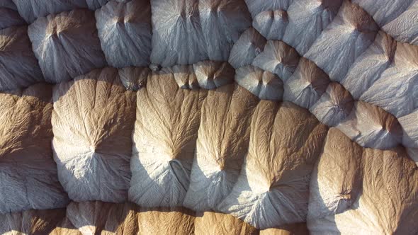 Industrial salt mining. Aerial view of a quarry for the extraction of minerals. Mountains of salt.