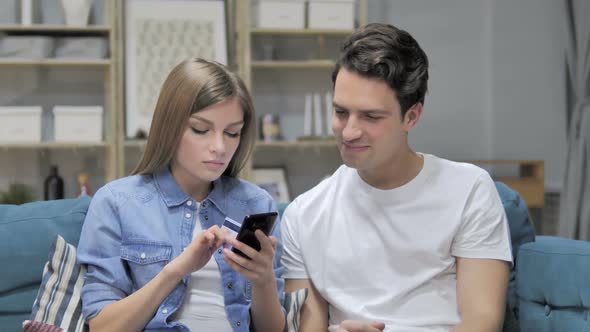 Young Couple Doing Online Shopping on Smartphone